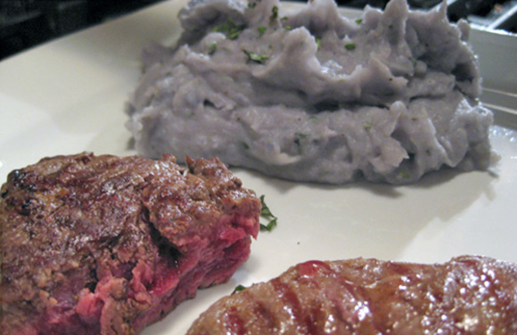 blue mashed potatoes prepared with fresh herbs and served with bison