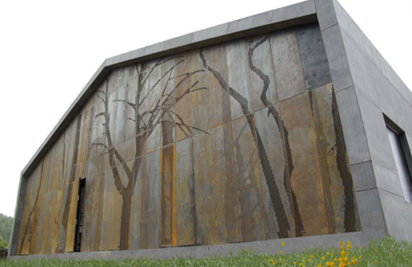 forest wall of a modern prefab house in cedeira designed by mycc