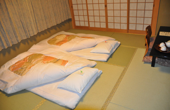 sleeping on a futon spread on the tatami floor at a ryokan